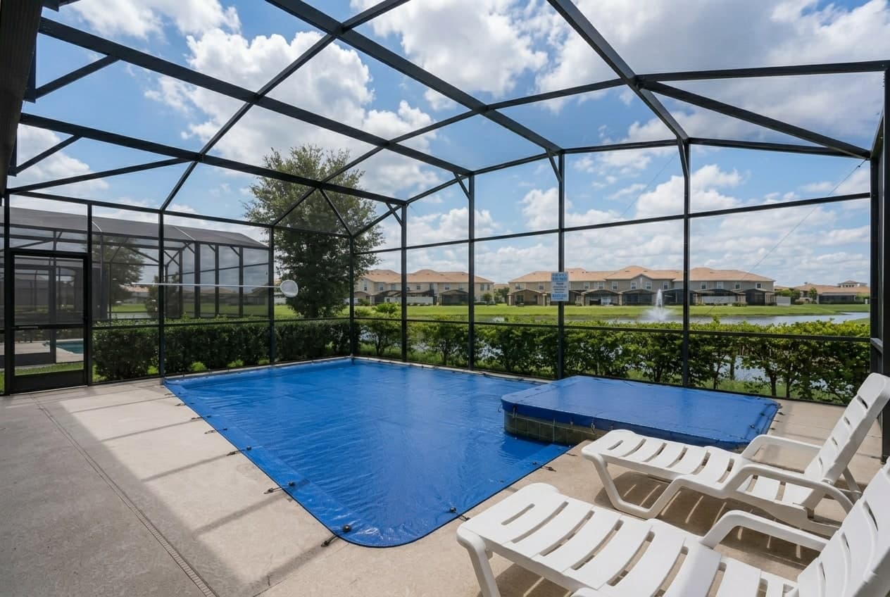 Pineapool cover anchored along a stone side deck, pulled flat and taut